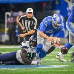 Detroit Lions quarterback Matthew Stafford (9) is stripped of the ball by Seattle Seahawks defensive tackle Jarran Reed (90)