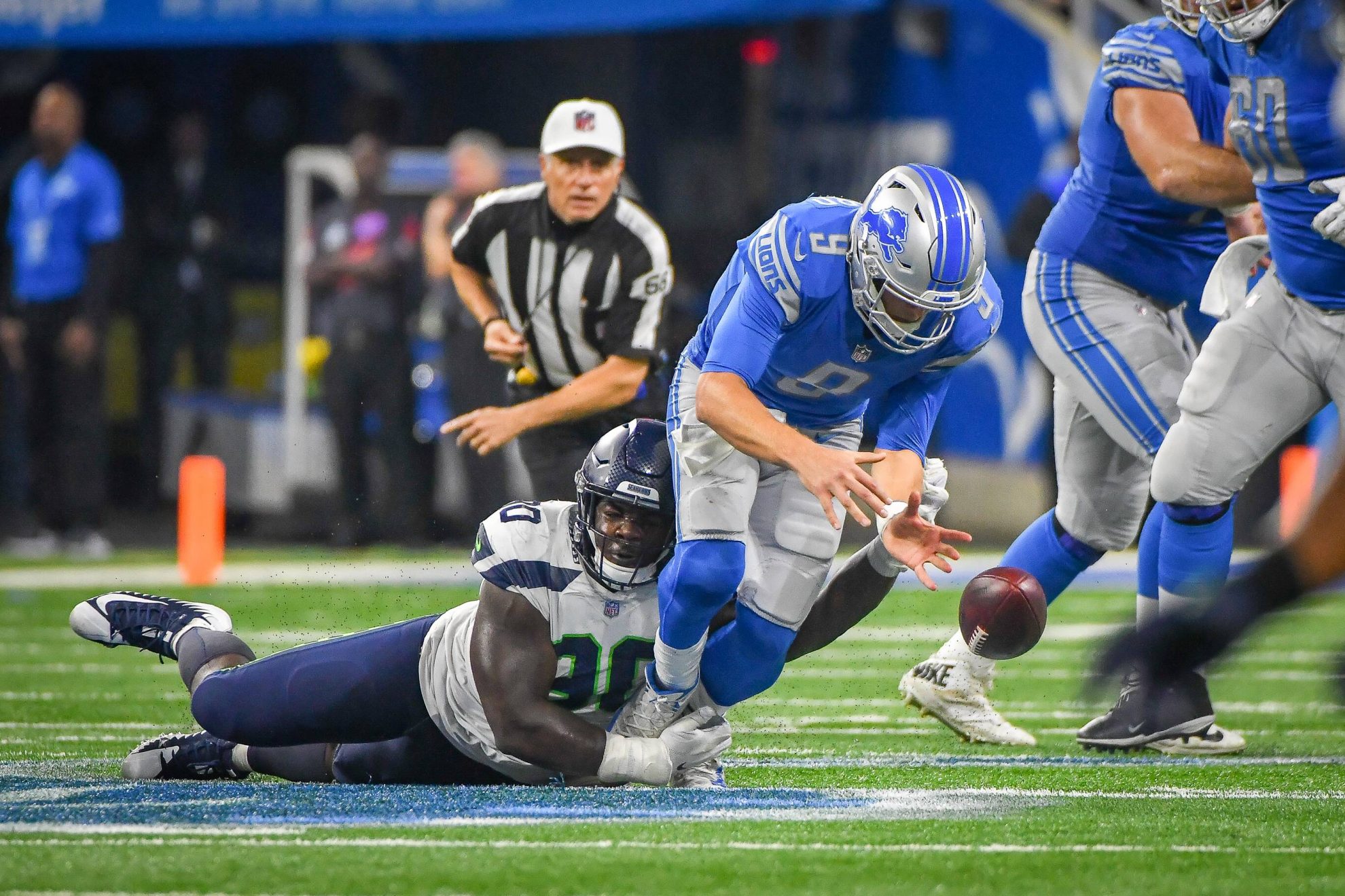 Detroit Lions quarterback Matthew Stafford (9) is stripped of the ball by Seattle Seahawks defensive tackle Jarran Reed (90)