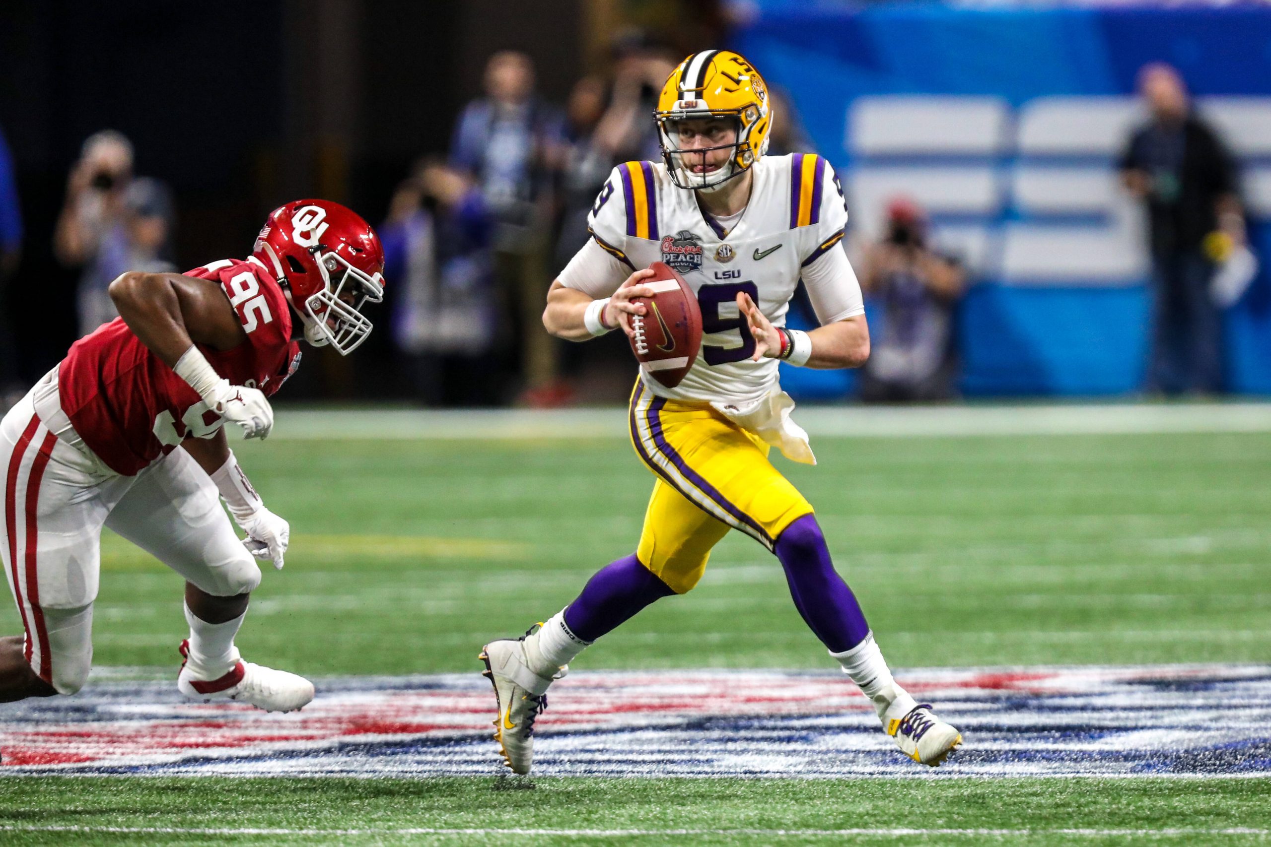 LSU s Joe Burrow 9 scrambles during the Chick-Fil-A Peach Bowl - a College Football Playoff Nationall Semifinal - featuring the Oklahoma Sooners and the LSU Tigers, played at Mercedes Benz Stadium in Atlanta, Georgia. /CSM NCAA, College League, USA Football 2019