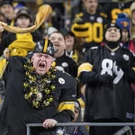 PITTSBURGH, PA - NOVEMBER 10: A Pittsburgh Steelers fan waves a terrible towel during the NFL, American Football Herren,