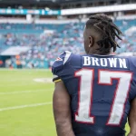 MIAMI GARDENS, FL - SEPTEMBER 15: New England Patriots Wide Receiver Antonio Brown (17) watches the game on the sidelin