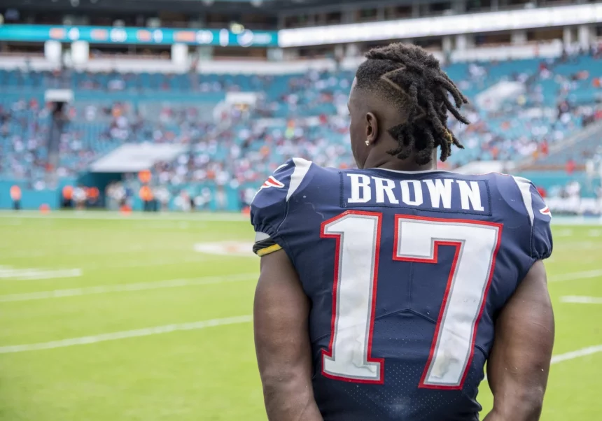 MIAMI GARDENS, FL - SEPTEMBER 15: New England Patriots Wide Receiver Antonio Brown (17) watches the game on the sidelin