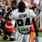 GLENDALE, AZ - AUGUST 15: Oakland Raiders wide receiver Antonio Brown (84) gestures to the crowd to get louder before t