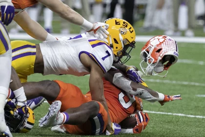 January 13, 2020, New Orleans, Louisiana, USA: 7 GRANT DELPIT, S of the LSU Tigers tackles 9 TRAVIS ETIENNE, RB of the C