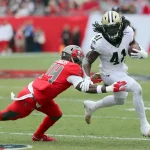 TAMPA, FL - NOV 17: Mike Edwards (34) of the Bucs attempts to wrap up Alvin Kamara (41) of the Saints during the regular