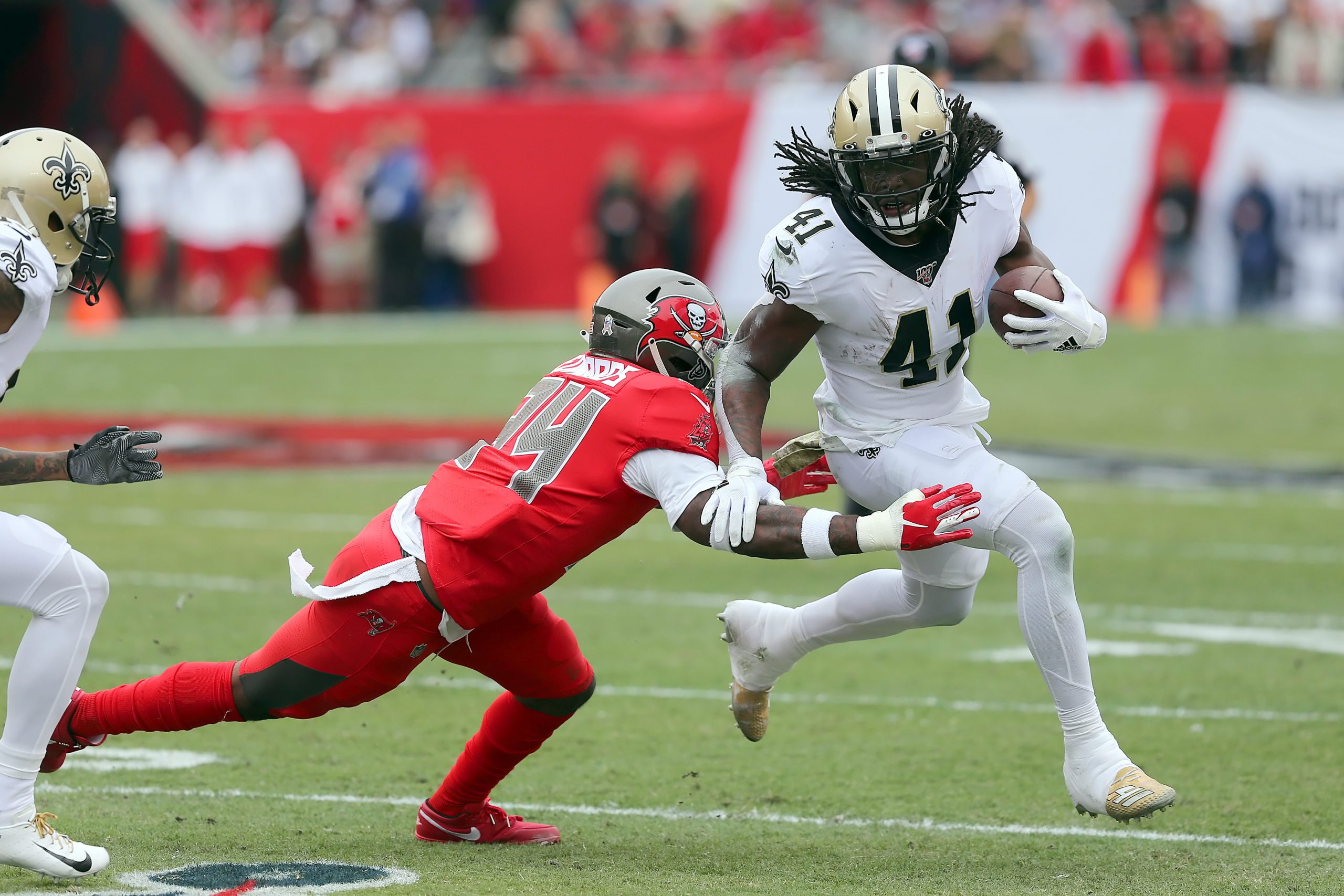 TAMPA, FL - NOV 17: Mike Edwards (34) of the Bucs attempts to wrap up Alvin Kamara (41) of the Saints during the regular