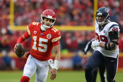 KANSAS CITY, MO - JANUARY 12: Kansas City Chiefs quarterback Patrick Mahomes (15) runs past Houston Texans defensive en
