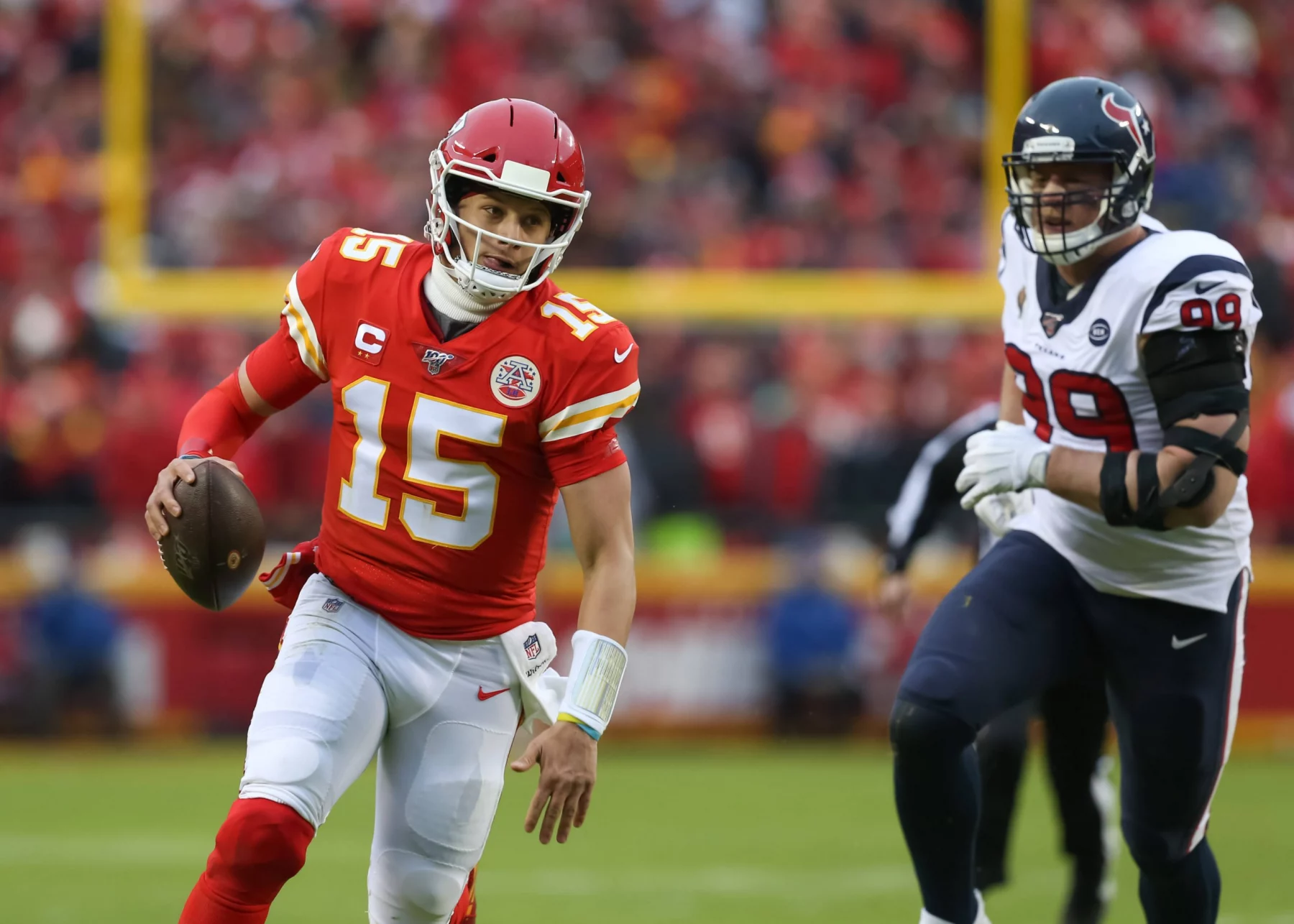 KANSAS CITY, MO - JANUARY 12: Kansas City Chiefs quarterback Patrick Mahomes (15) runs past Houston Texans defensive en