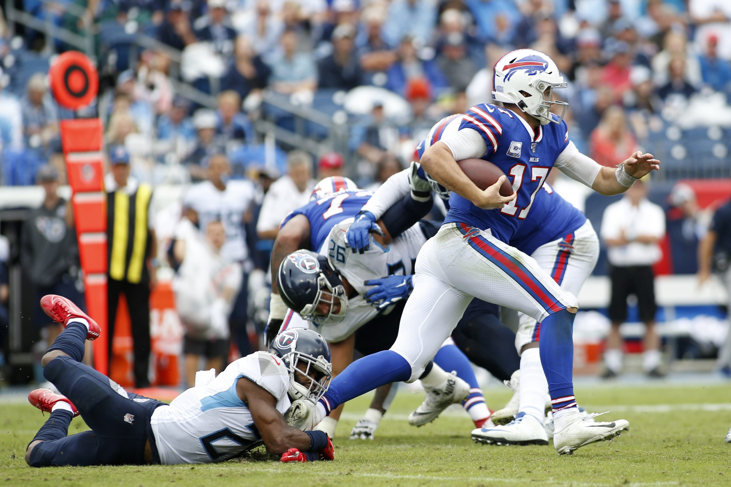 NASHVILLE, TN - OCTOBER 06: Buffalo Bills quarterback Josh Allen (17) escapes a tackle of Tennessee Titans cornerback Ma