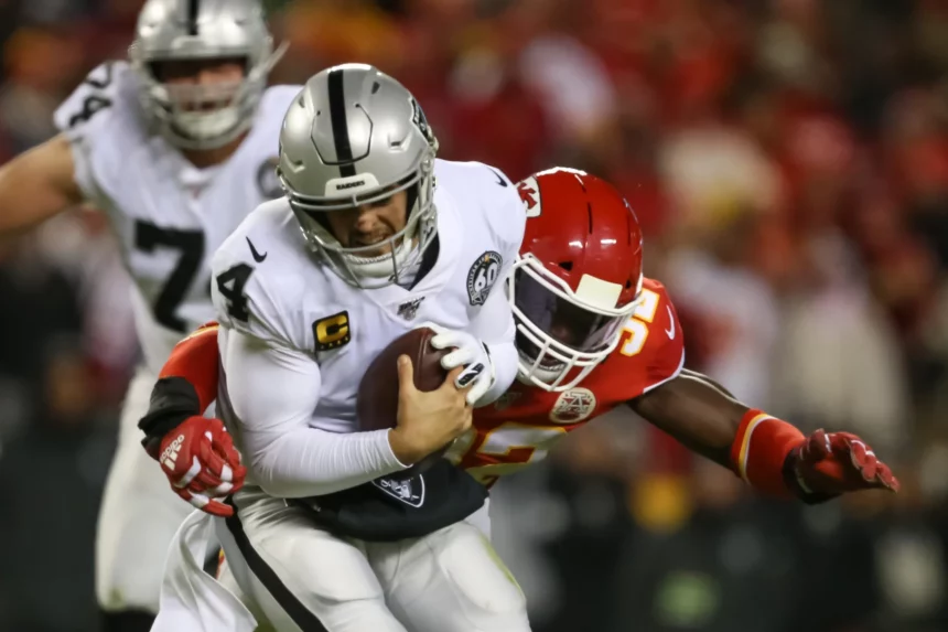 KANSAS CITY, MO - DECEMBER 01: Oakland Raiders quarterback Derek Carr (4) is sacked by Kansas City Chiefs defensive end