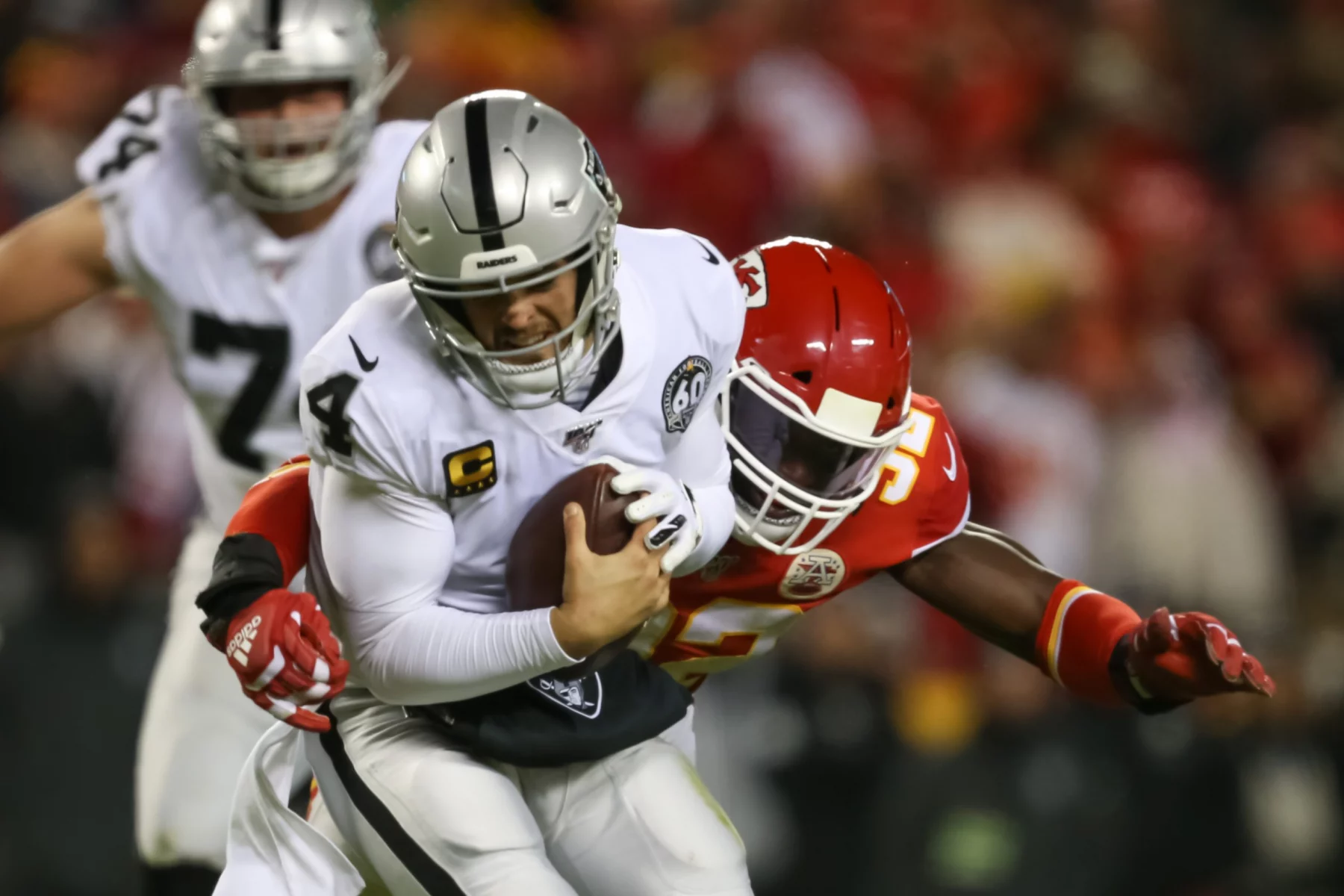 KANSAS CITY, MO - DECEMBER 01: Oakland Raiders quarterback Derek Carr (4) is sacked by Kansas City Chiefs defensive end
