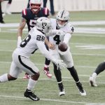 FOXBOROUGH, MA - SEPTEMBER 27: Las Vegas Raiders quarterback Derek Carr (4) hands off to Las Vegas Raiders running back