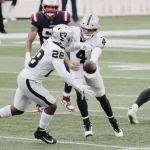 FOXBOROUGH, MA - SEPTEMBER 27: Las Vegas Raiders quarterback Derek Carr (4) hands off to Las Vegas Raiders running back