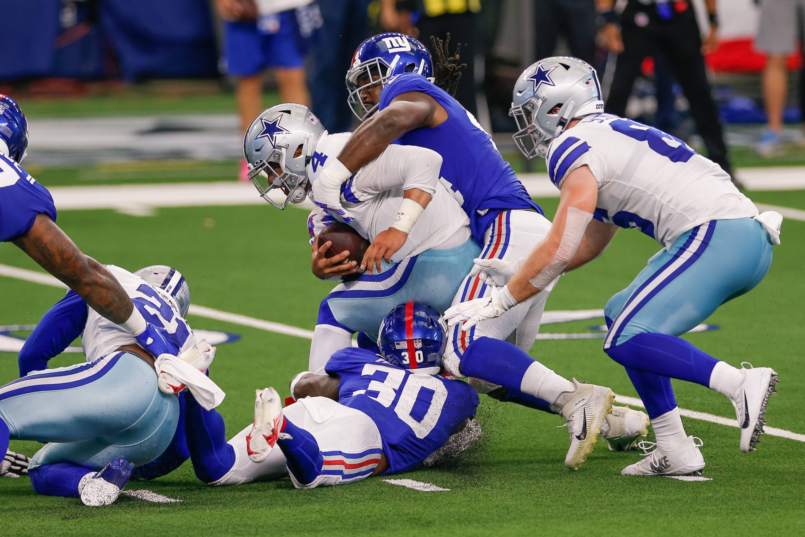 ARLINGTON, TX - OCTOBER 11: Dallas Cowboys Quarterback Dak Prescott (4) is sacked by New York Giants Linebacker Markus G