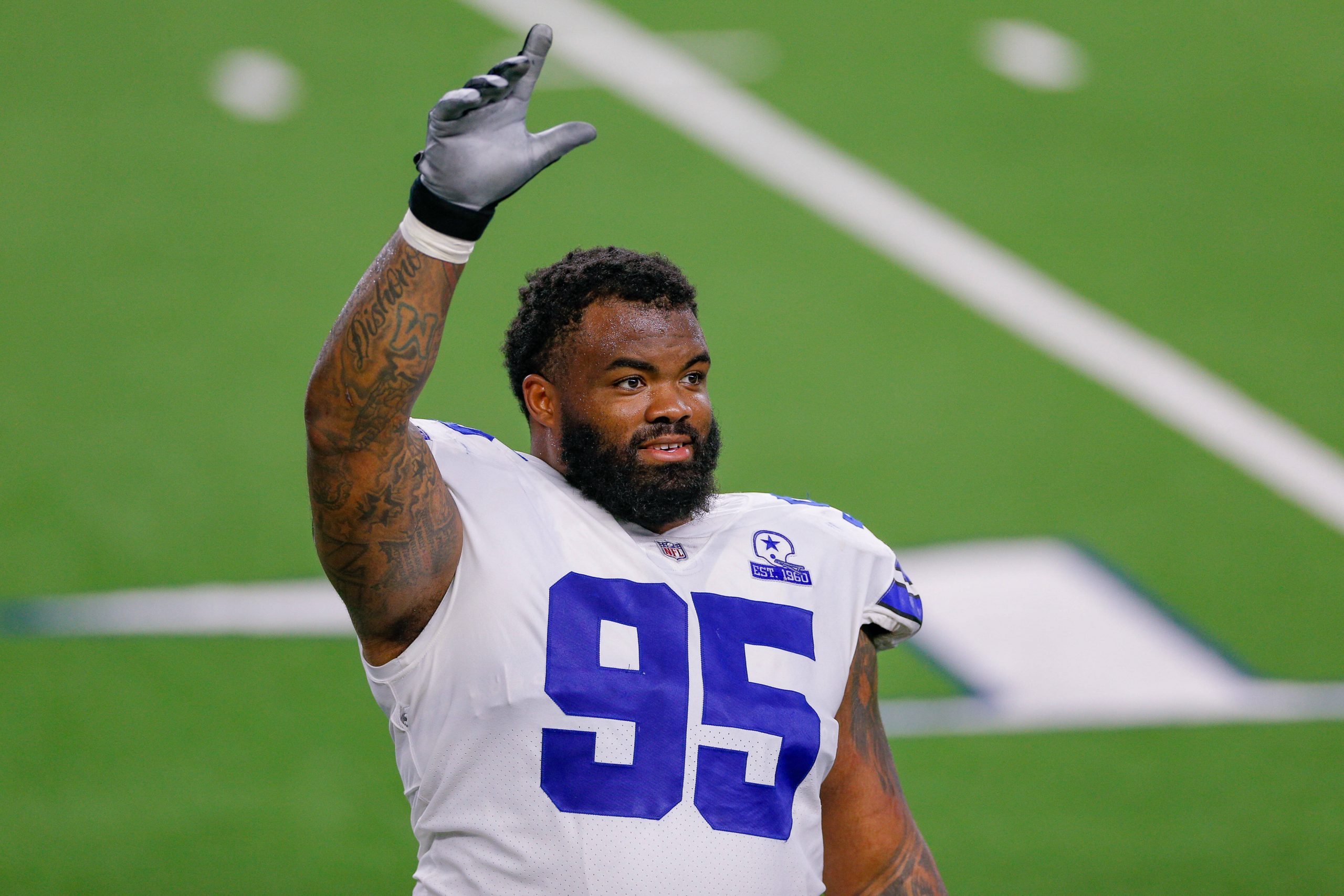 ARLINGTON, TX - OCTOBER 11: Dallas Cowboys Defensive Tackle Dontari Poe (95) waves to fans following the NFL, American F