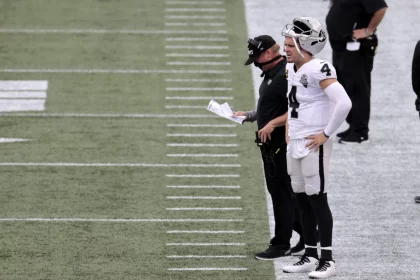 FOXBOROUGH, MA - SEPTEMBER 27: Las Vegas Raiders head coach Jon Gruden and Las Vegas Raiders quarterback Derek Carr (4)