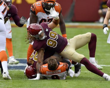 LANDOVER, MD - NOVEMBER 22: Bengals quarterback Joe Burrow (9) is sacked by Washington defensive end Chase Young (99) an