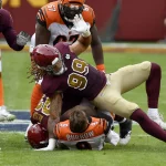LANDOVER, MD - NOVEMBER 22: Bengals quarterback Joe Burrow (9) is sacked by Washington defensive end Chase Young (99) an