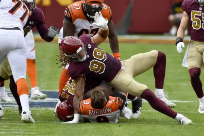 LANDOVER, MD - NOVEMBER 22: Bengals quarterback Joe Burrow (9) is sacked by Washington defensive end Chase Young (99) an