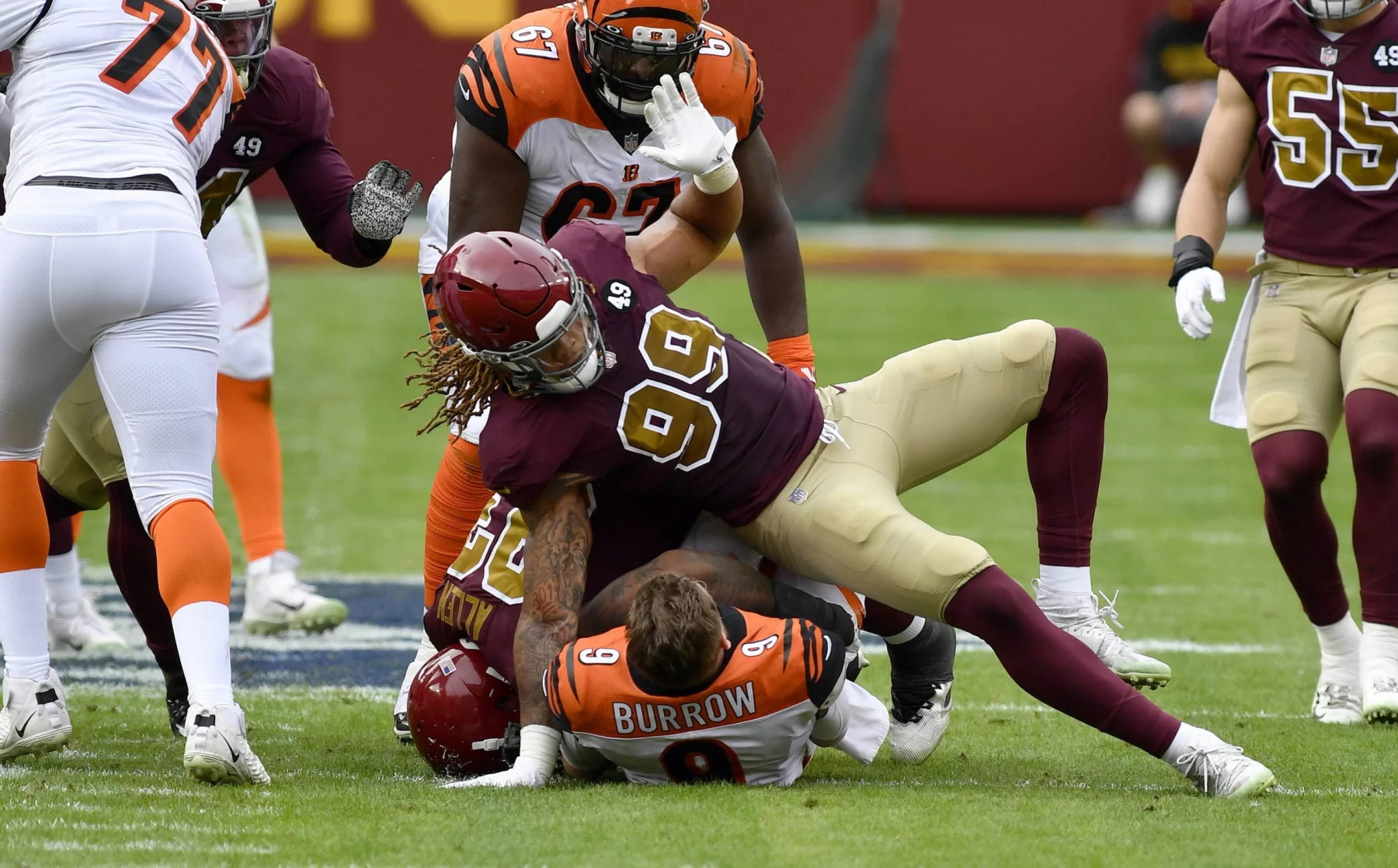 LANDOVER, MD - NOVEMBER 22: Bengals quarterback Joe Burrow (9) is sacked by Washington defensive end Chase Young (99) an