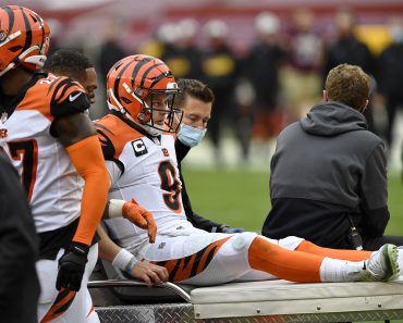 LANDOVER, MD - NOVEMBER 22: Joe Burrow (9) reacts as he is carted off the field after being injured during the Cincinna
