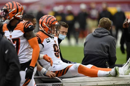 LANDOVER, MD - NOVEMBER 22: Joe Burrow (9) reacts as he is carted off the field after being injured during the Cincinna