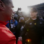 Michigan head coach Jim Harbaugh right shakes hands with Ohio Urban Meyer