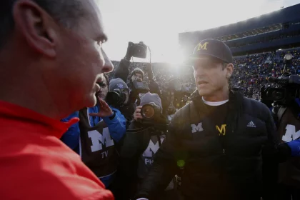 Michigan head coach Jim Harbaugh right shakes hands with Ohio Urban Meyer