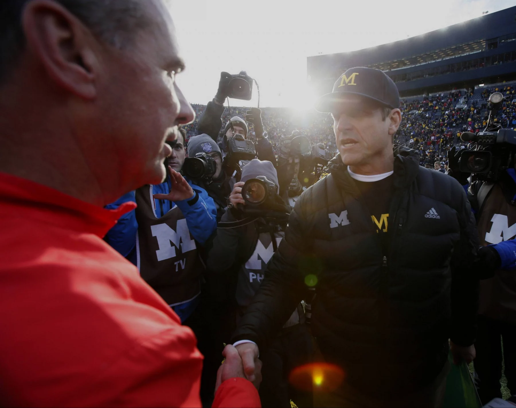 Michigan head coach Jim Harbaugh right shakes hands with Ohio Urban Meyer
