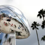 September 19, 2021, TAMPA, Florida, USA: Arriving football fans are reflected in a larger-than-life rendition of the Vi