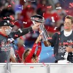 TAMPA, FL - FEBRUARY 07: Super Bowl MVP Tom Brady (12) of the Buccaneers accepts the Lombardi Trophy from General Manage
