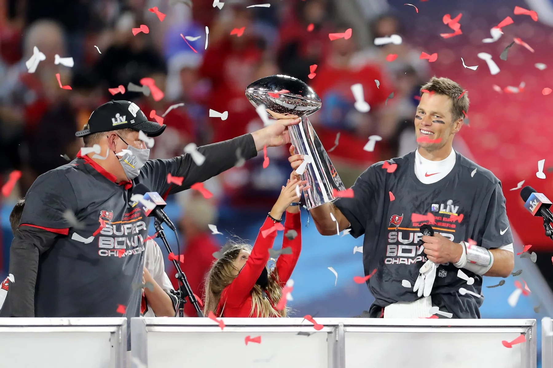 TAMPA, FL - FEBRUARY 07: Super Bowl MVP Tom Brady (12) of the Buccaneers accepts the Lombardi Trophy from General Manage