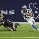 HOUSTON, TX - SEPTEMBER 23: Carolina Panthers running back Christian McCaffrey (22) evades a tackle by Houston Texans in