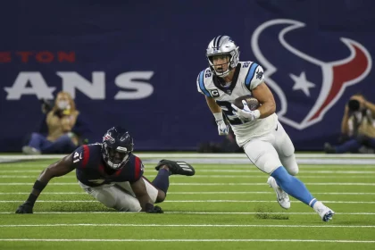 HOUSTON, TX - SEPTEMBER 23: Carolina Panthers running back Christian McCaffrey (22) evades a tackle by Houston Texans in
