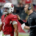 Arizona Cardinals head coach Cliff Kingsbury R sends quarterback Kyler Murray back into the game