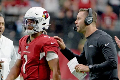 Arizona Cardinals head coach Cliff Kingsbury R sends quarterback Kyler Murray back into the game