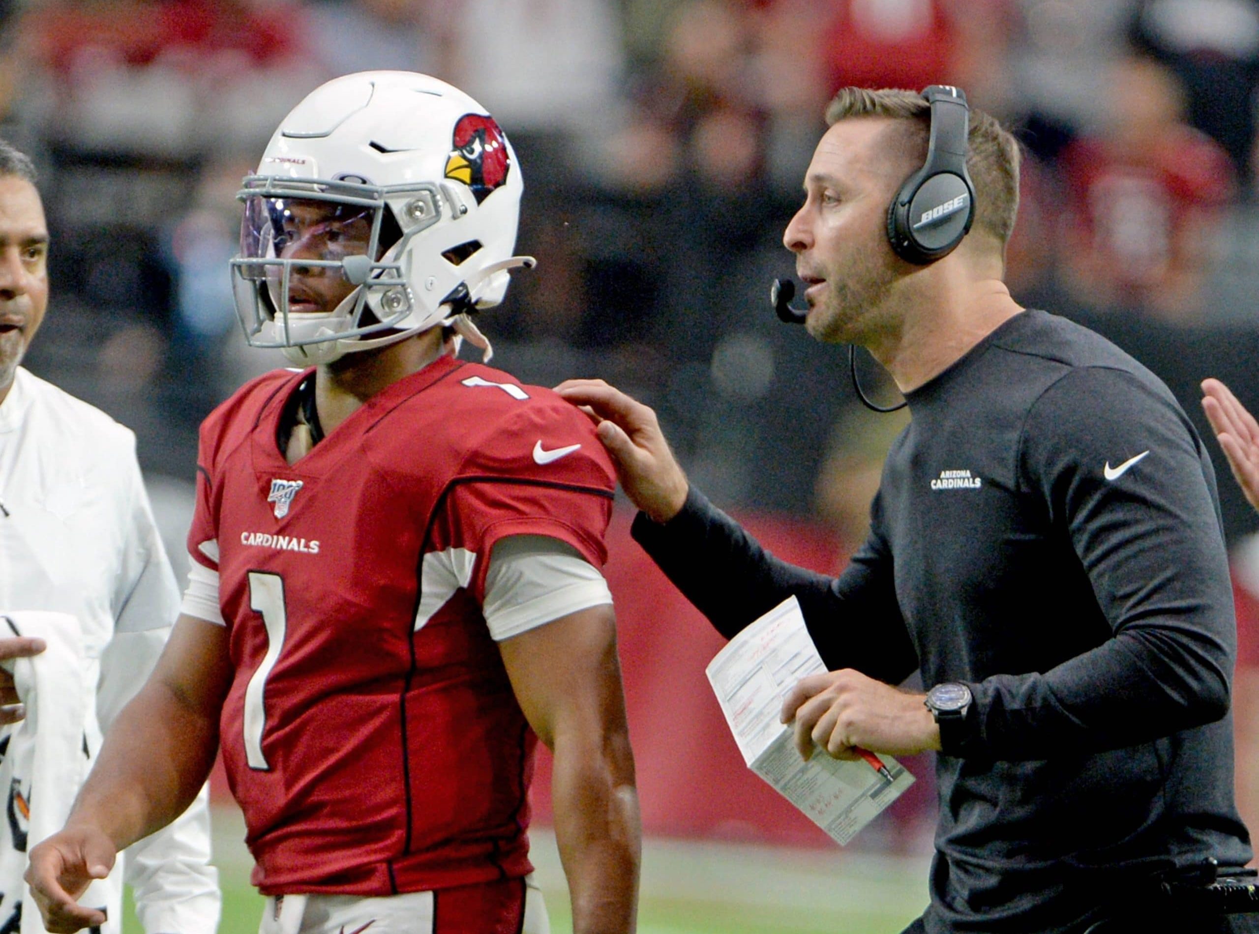 Arizona Cardinals head coach Cliff Kingsbury R sends quarterback Kyler Murray back into the game