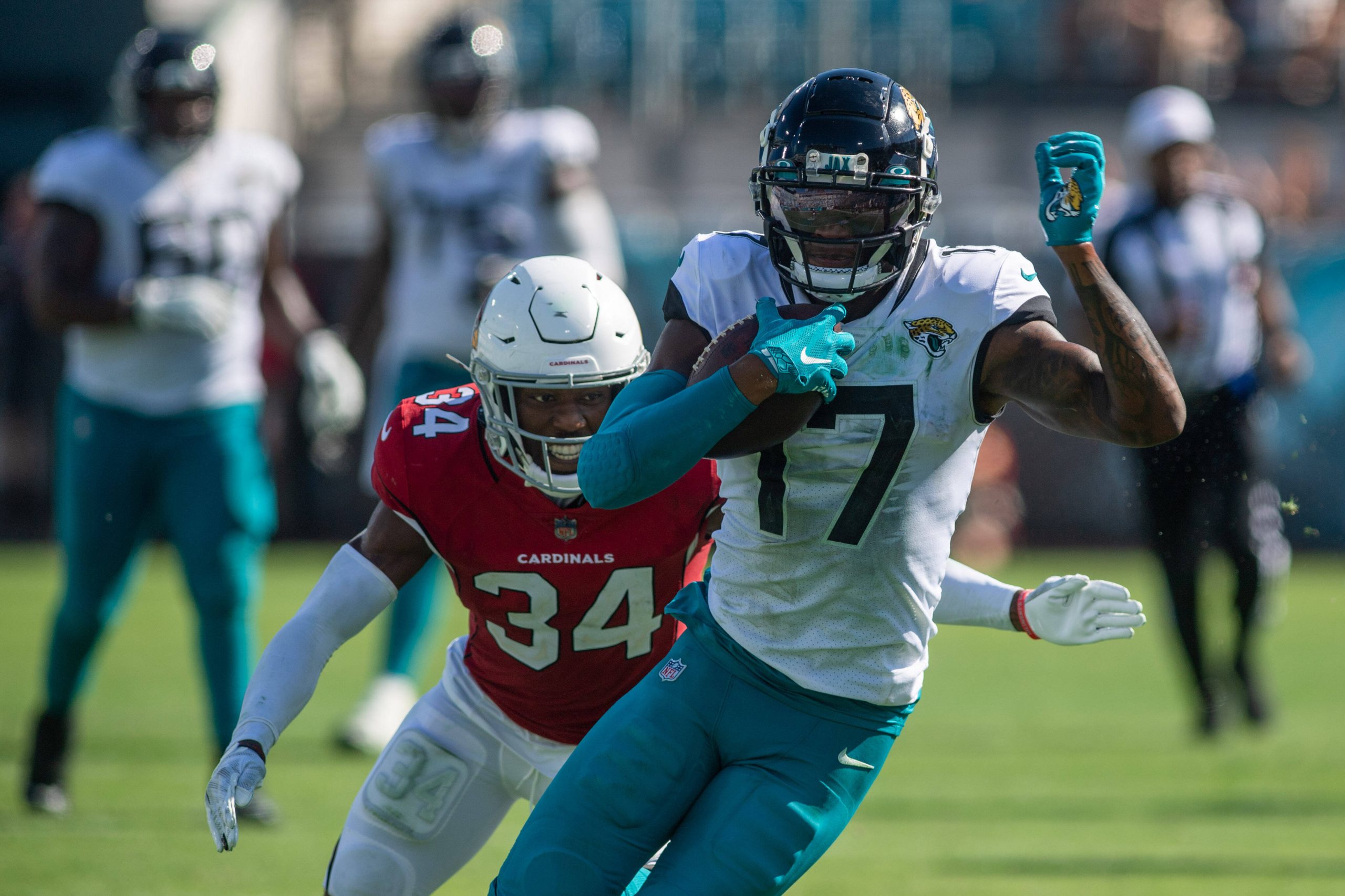 September 26, 2021, Syracuse, New York, USA: Jacksonville Jaguars wide receiver D.J. CHARK (17) tries to juke past Arizo