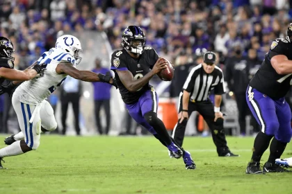 BALTIMORE, MD - OCTOBER 11: Baltimore Ravens quarterback Lamar Jackson (8) scrambles away form pressure by Colts defensi