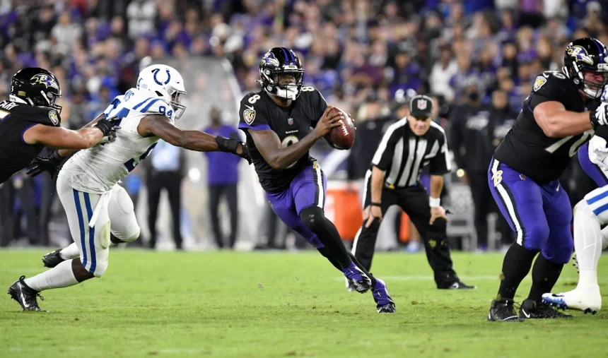 BALTIMORE, MD - OCTOBER 11: Baltimore Ravens quarterback Lamar Jackson (8) scrambles away form pressure by Colts defensi