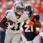 DENVER, CO - OCTOBER 17: Las Vegas Raiders wide receiver Henry Ruggs III (11) fights off Denver Broncos cornerback Rona