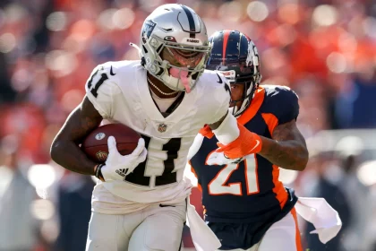 DENVER, CO - OCTOBER 17: Las Vegas Raiders wide receiver Henry Ruggs III (11) fights off Denver Broncos cornerback Rona