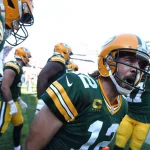 October 17, 2021: Green Bay Packers quarterback Aaron Rodgers celebrates with his teammates after rushing for a touchdow