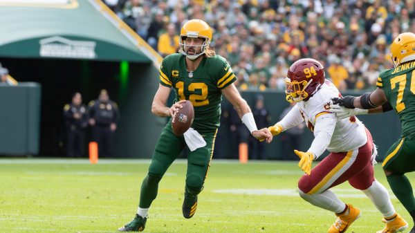 October 24, 2021: Green Bay Packers quarterback Aaron Rodgers 12 avoids a sack by Washington Football Team defensive tac