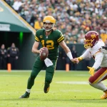 October 24, 2021: Green Bay Packers quarterback Aaron Rodgers 12 avoids a sack by Washington Football Team defensive tac