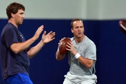 April 11, 2013 - Durham, NC, USA - Peyton Manning and his brother Eli run through drills during a wo