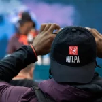INDIANAPOLIS IN MARCH 02 A Scouting Combine participant takes a photo of his college teammate on