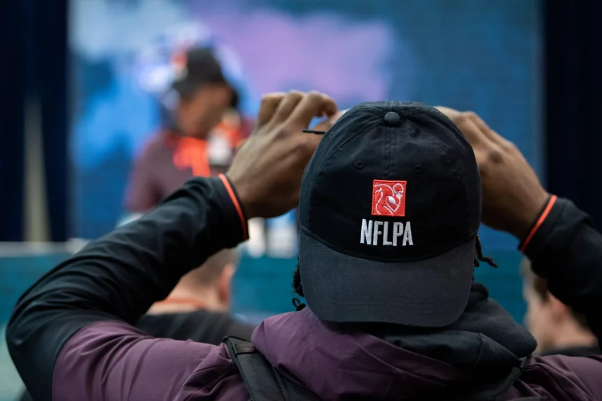 INDIANAPOLIS IN MARCH 02 A Scouting Combine participant takes a photo of his college teammate on