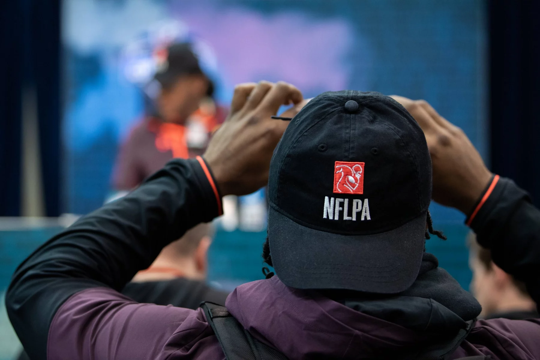 INDIANAPOLIS IN MARCH 02 A Scouting Combine participant takes a photo of his college teammate on