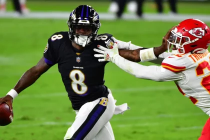 Baltimore Ravens quarterback Lamar Jackson (8) pushes Kansas City Chiefs safety Juan Thornhill (22) away during the firs